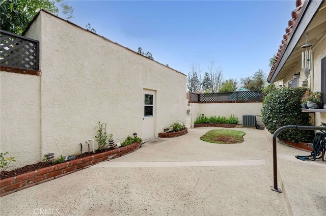 view of patio / terrace with cooling unit and fence