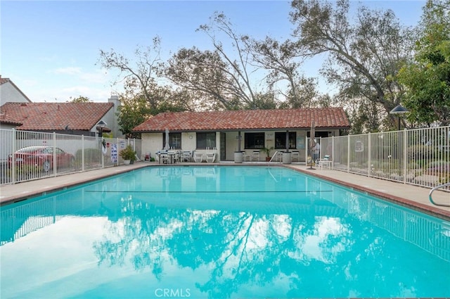 pool featuring a patio area and fence