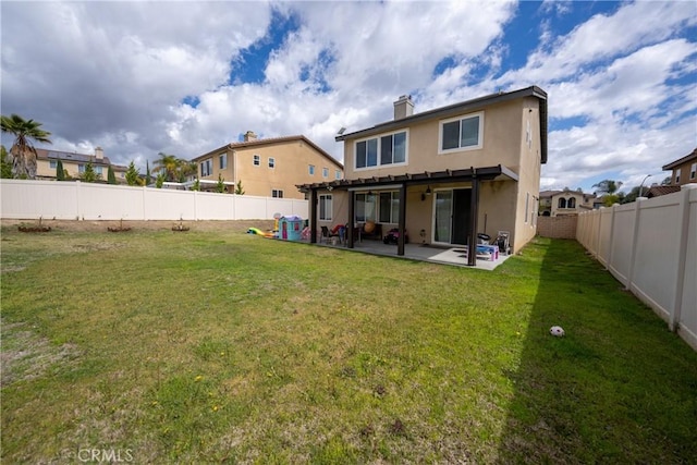 back of property with a patio, a lawn, and a fenced backyard