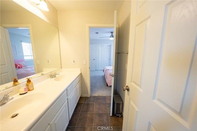 full bathroom with a sink, double vanity, and connected bathroom