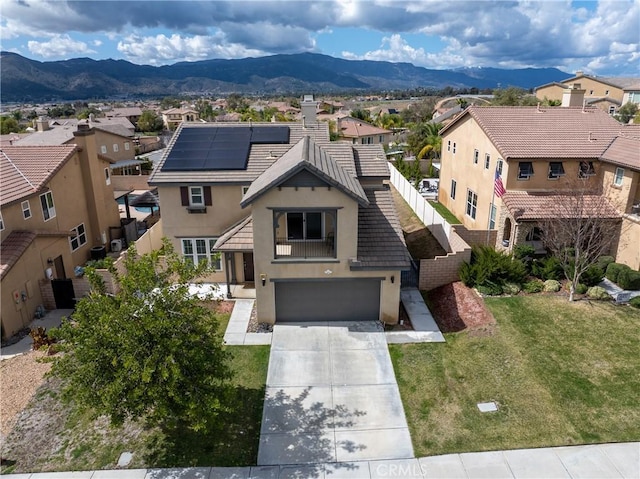 view of front of house featuring a residential view, a mountain view, and stucco siding