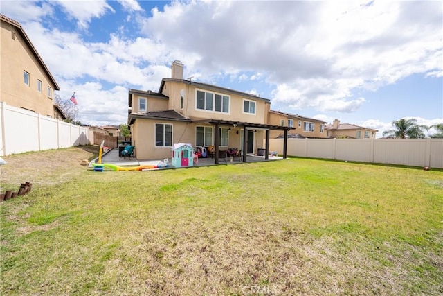 rear view of house with a lawn, a patio area, a fenced backyard, and stucco siding