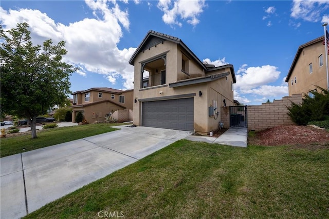 view of front of home with an attached garage, concrete driveway, a gate, stucco siding, and a front yard