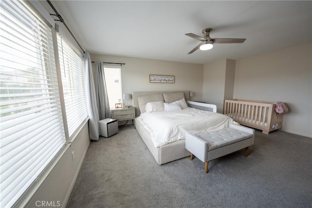 carpeted bedroom with a ceiling fan and baseboards