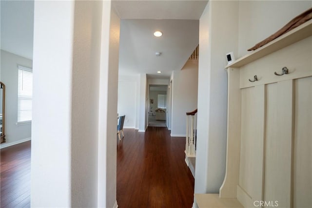 hall with baseboards, stairway, and dark wood finished floors