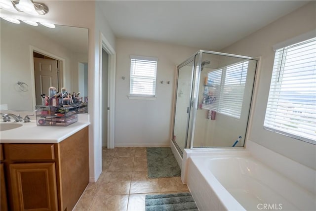 full bathroom with tile patterned flooring, vanity, baseboards, a bath, and a stall shower