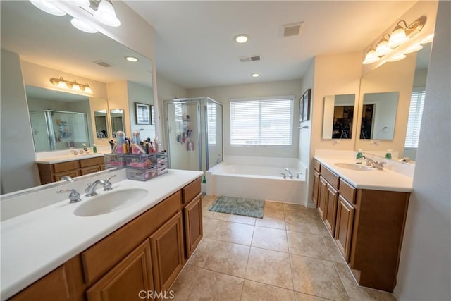 bathroom with tile patterned flooring, visible vents, and a sink