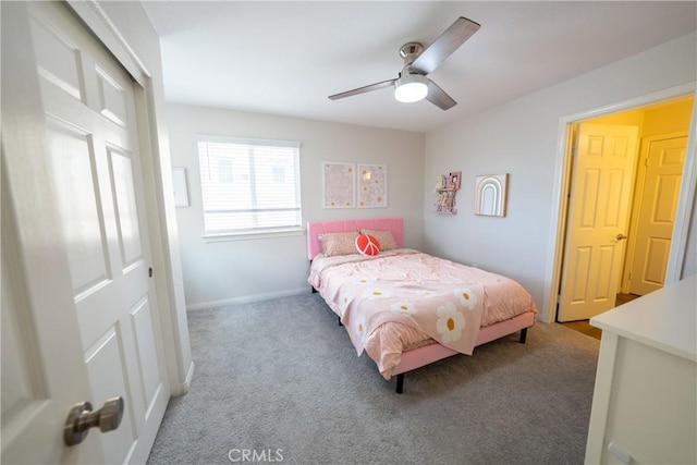 carpeted bedroom with ceiling fan and baseboards