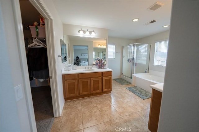 bathroom with plenty of natural light, visible vents, tile patterned flooring, and a shower stall