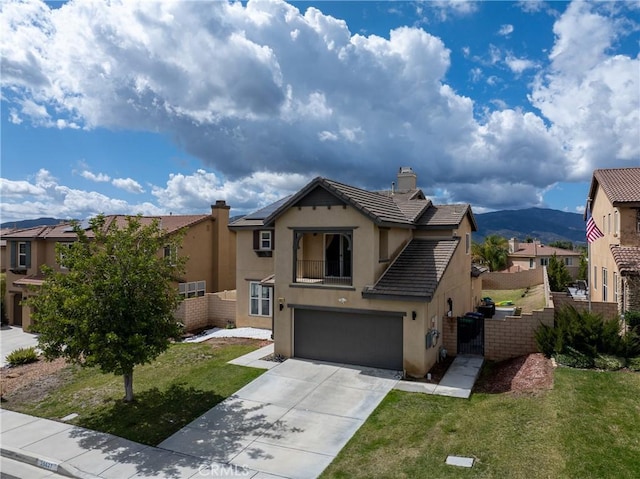 view of front of house with driveway, a tile roof, fence, a front lawn, and stucco siding