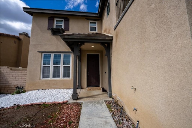 doorway to property with stucco siding