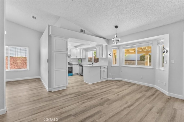 unfurnished living room with light wood finished floors, baseboards, lofted ceiling, and a sink