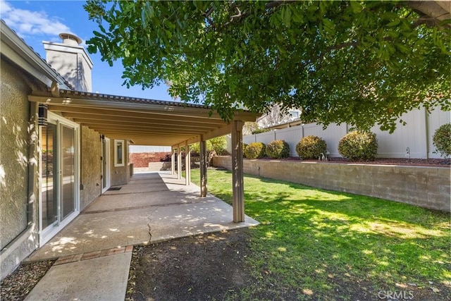 view of yard with fence and a patio area