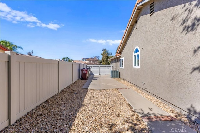 view of yard with a patio, cooling unit, and a fenced backyard