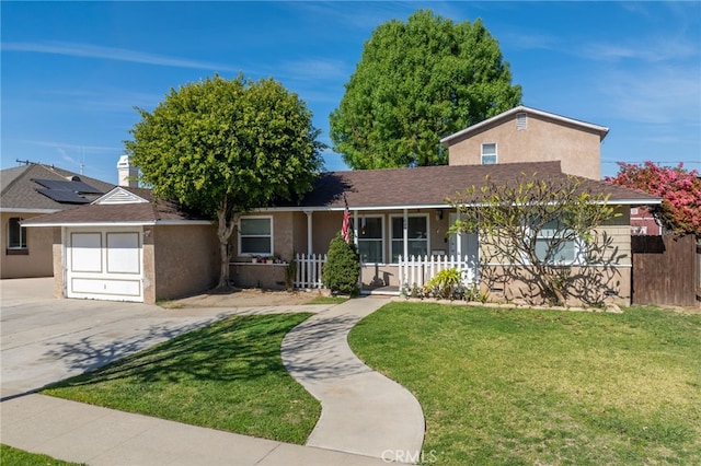 view of front facade with stucco siding, fence, a garage, driveway, and a front lawn