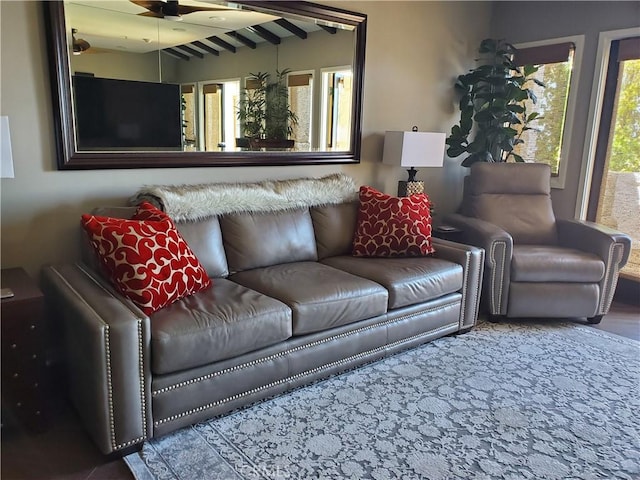 living area featuring lofted ceiling with beams