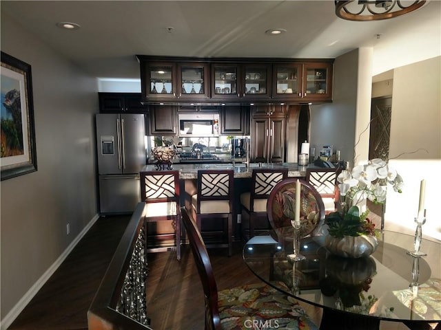 interior space with baseboards, dark wood finished floors, and recessed lighting