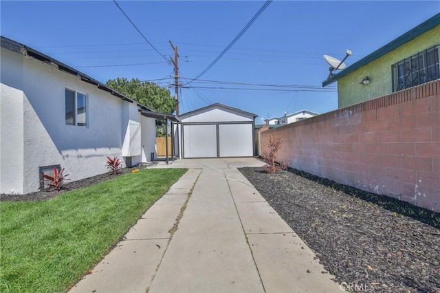 view of yard with an outdoor structure and fence