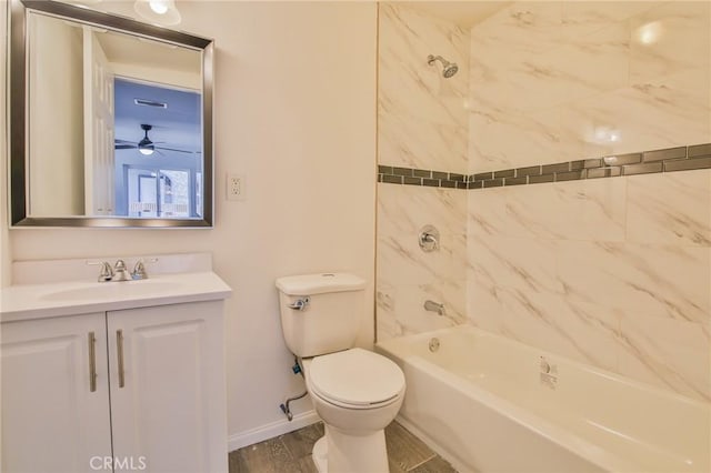 full bath with toilet, wood finished floors, vanity, baseboards, and shower / washtub combination