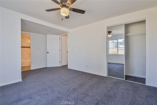 unfurnished bedroom featuring a closet, dark carpet, a ceiling fan, and baseboards