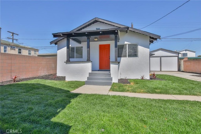 view of front of house featuring a front yard, fence, and stucco siding