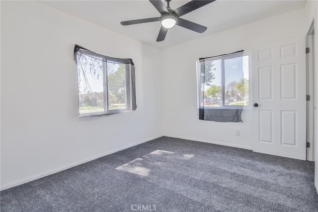 unfurnished room with carpet floors, a healthy amount of sunlight, and baseboards