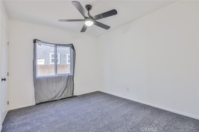 empty room with carpet, ceiling fan, and baseboards