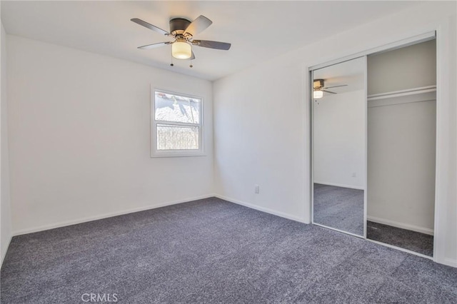 unfurnished bedroom featuring a closet, carpet flooring, ceiling fan, and baseboards