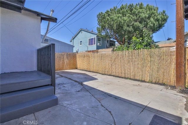 view of patio featuring fence