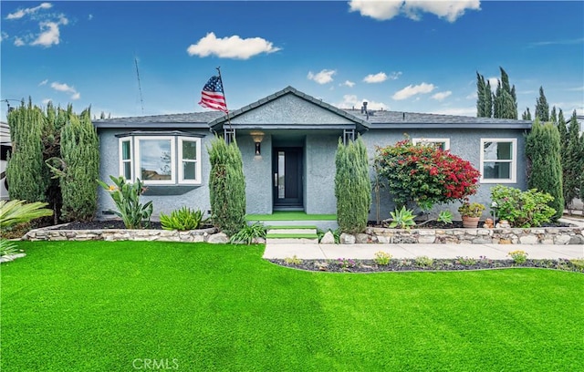 view of front of property with a front yard and stucco siding