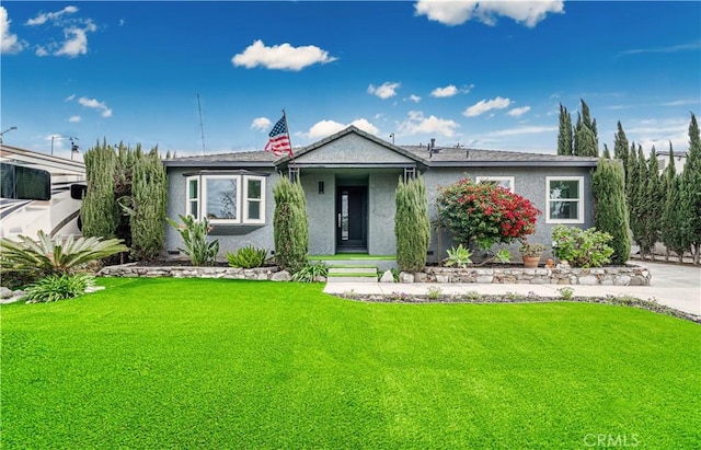 view of front of property with a front lawn and stucco siding