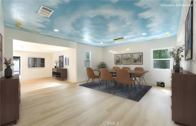 dining room featuring wood finished floors and visible vents