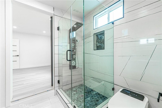 full bath featuring visible vents, a stall shower, toilet, and baseboards