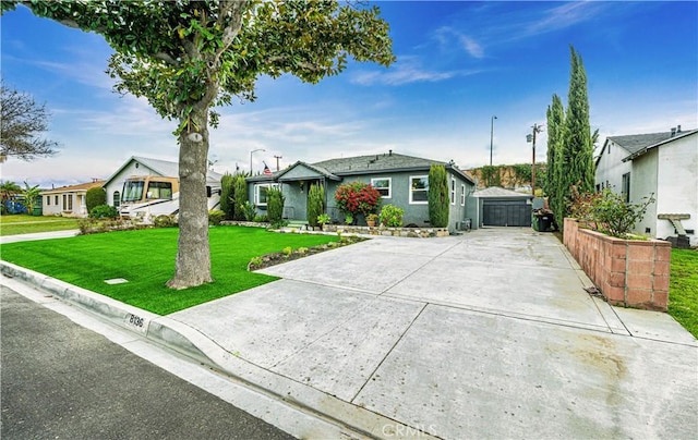 view of front of house with a front yard, driveway, a residential view, and an outbuilding