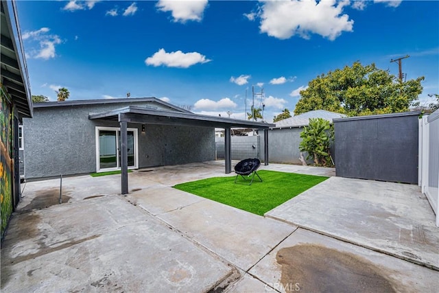 exterior space with an outdoor fire pit and a fenced backyard