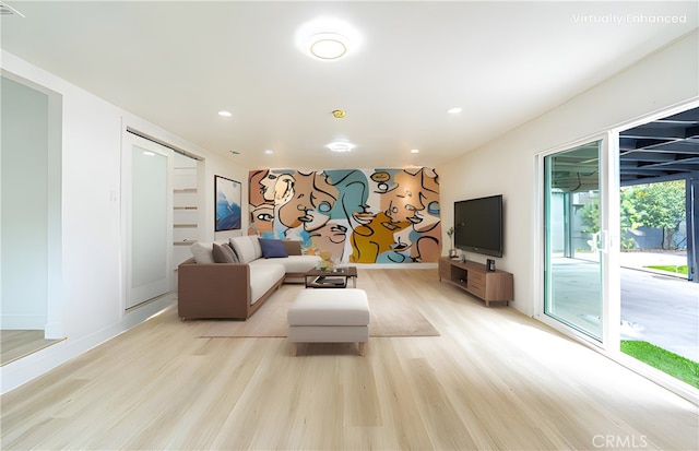 living area featuring light wood-style flooring, baseboards, and recessed lighting