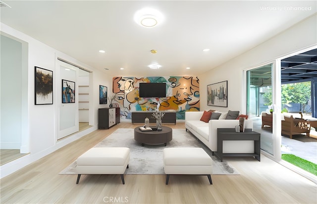 living room featuring light wood-style floors, recessed lighting, and baseboards