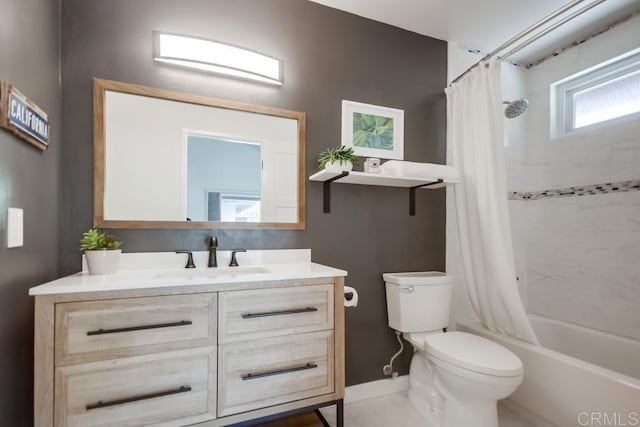 bathroom featuring baseboards, toilet, shower / bath combo, and vanity