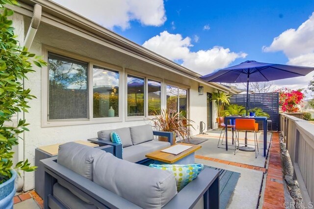 view of patio / terrace with outdoor dining space and an outdoor hangout area