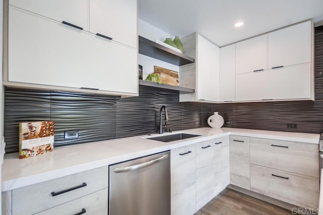 kitchen with open shelves, dishwasher, light countertops, modern cabinets, and a sink