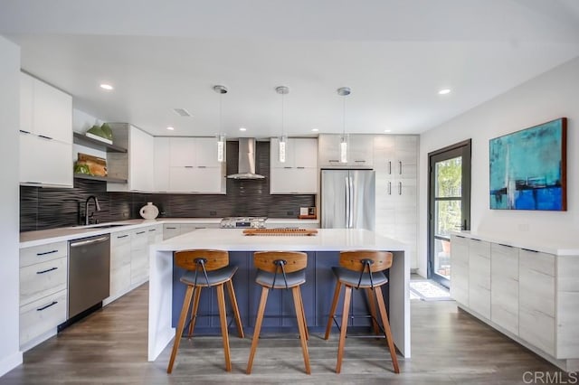 kitchen with open shelves, a sink, stainless steel appliances, wall chimney exhaust hood, and modern cabinets