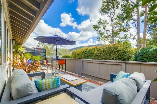 balcony with an outdoor living space and a patio area