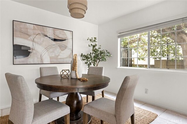 dining room featuring light tile patterned floors and baseboards