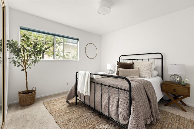 carpeted bedroom featuring baseboards