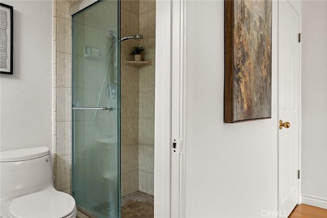 bathroom with toilet and a shower stall