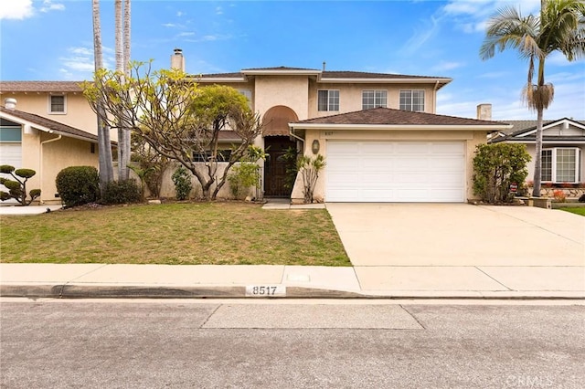 view of front of house with stucco siding, driveway, an attached garage, and a front yard