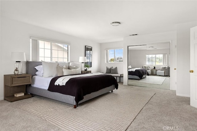 bedroom featuring visible vents, baseboards, a closet, and carpet flooring