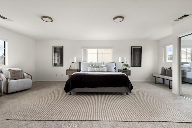 bedroom with visible vents, carpet flooring, and baseboards