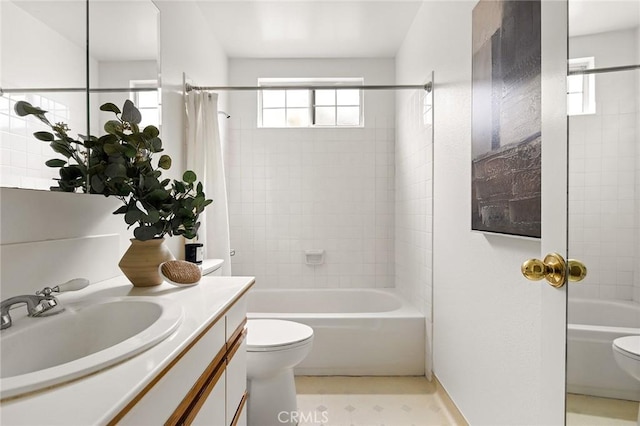 bathroom featuring vanity, shower / bath combination with curtain, and toilet