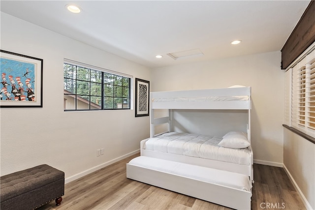 bedroom featuring baseboards, wood finished floors, and recessed lighting